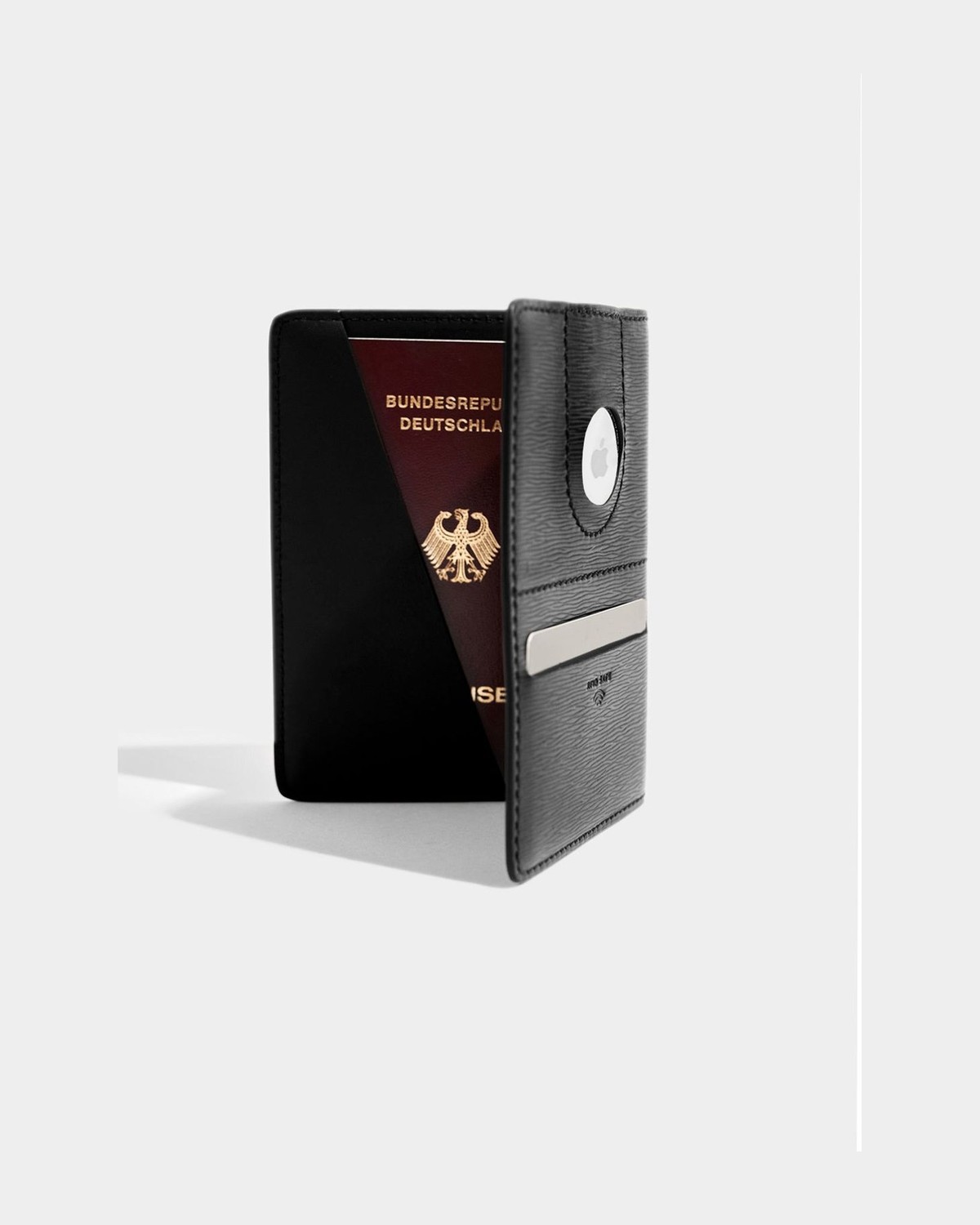 VOCIER leather passport holder open, with an Apple AirTag visible in its circular window