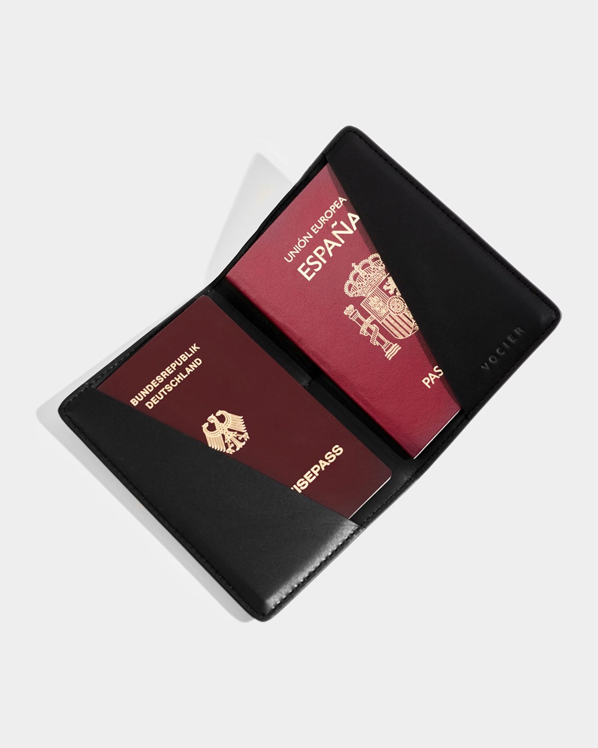 VOCIER leather passport holder open, holding two passports