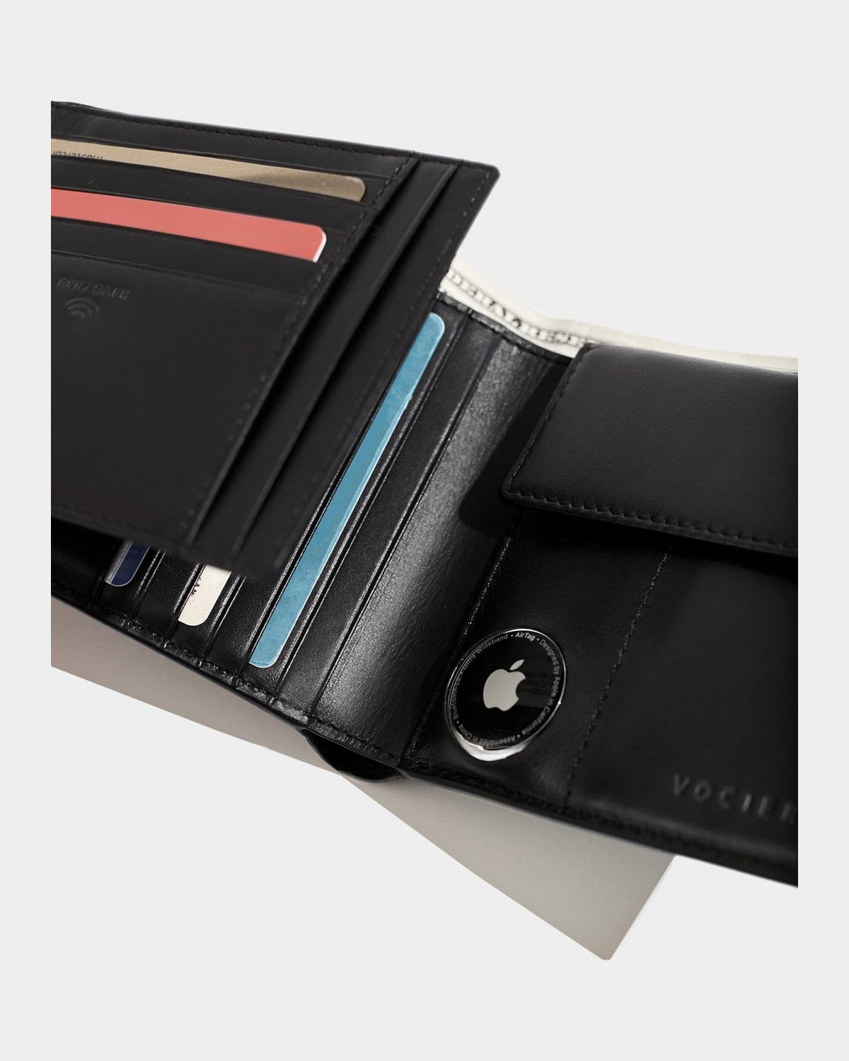 VOCIER trifold leather wallet in use, with an Apple AirTag in its circular pocket